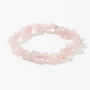 Detailed shot of handmade elastic bracelet with irregular natural pink quartz stones