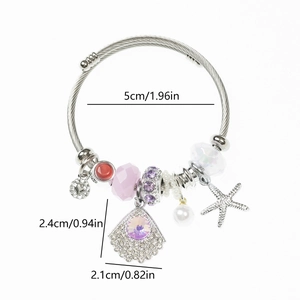 Detailed view of stainless steel charm bracelet with starfish and purple fan pendants