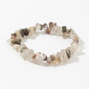 Detailed view of natural irregular white crystal and agate stone stretch bracelet