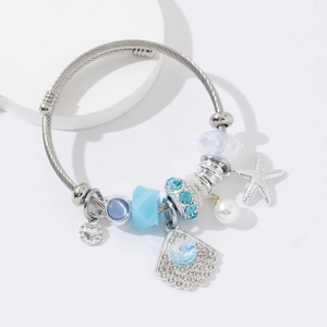 Silver cable charm bracelet with blue beads, starfish, shell, and heart pendants