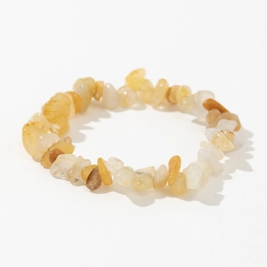 Macro view of elastic bracelet made of irregular yellow citrine and quartz crystal stones