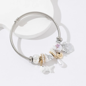 Silver stainless steel open bangle with purple star bead, heart and whale charms
