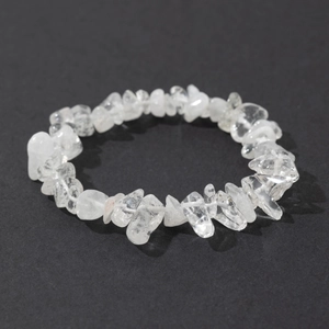 Macro detail of natural clear quartz chips elastic bracelet on black background