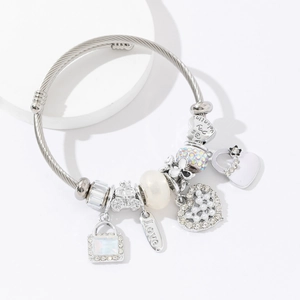 Silver cable bangle with heart charms, pearl beads and love pendants on white base