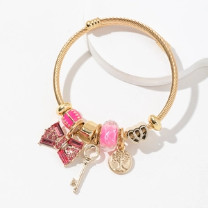 Golden stainless steel charm bracelet with life tree and pink crystal bow details