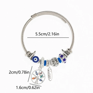 Detail of twisted cable bracelet featuring tree of life and blue evil eye charms