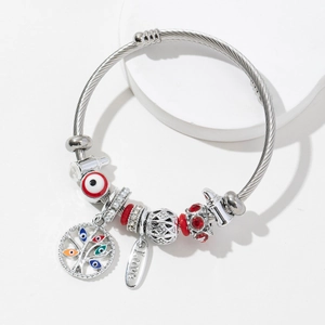Silver woven steel bracelet with Tree of Life charm and Evil Eye beads on white stand