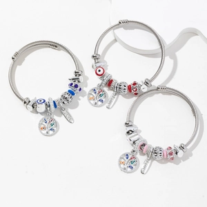 Three beaded stainless steel wire bracelets with Tree of Life and Evil Eye charms