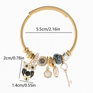 Detail of adjustable owl charm bracelet with pearl shell and love beads on gold wire