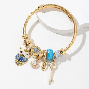 Adjustable gold owl bracelet with blue charms, shell pendant and pearl beads