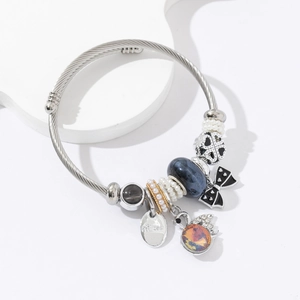 Silver stainless steel cable bracelet with blue marble bead and princess charm