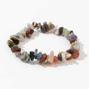 Detailed view of elastic bracelet with irregular natural amethyst and rose quartz stones