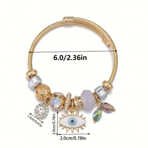 Macro view of evil eye gold charm bracelet with crystal beads and size measurements