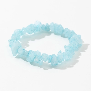 Close-up of light blue raw crystal chips elastic bracelet on a clean white background