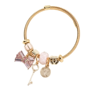 Golden twisted cable bracelet featuring pink crystal charms, bow, key, and tree of life