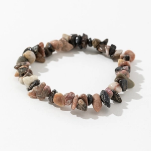 Macro shot of multi-colored natural raw stone elastic bracelet on white background
