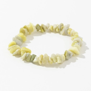 Detailed close-up of natural irregular yellow and green crystal stone elastic bracelet