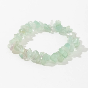 Detailed macro view of natural green fluorite irregular stone stretch bracelet