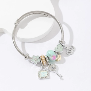 Silver stainless steel cable bracelet with charms featuring heart key and crown pendants
