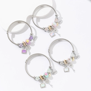 Close-up of stainless steel beaded bracelets with heart, crown and key charms