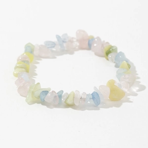 Macro shot of polished irregular amethyst and colorful glass stone beads on elastic bracelet