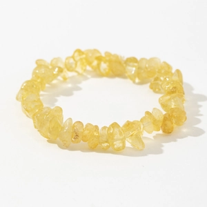 Detail of beaded bracelet with natural yellow crystal chips and elastic string