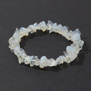 Close-up of bohemian irregular opal stone bracelet on a textured dark grey surface