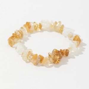 Detailed close-up of polished natural citrine and clear quartz stone beads on bracelet