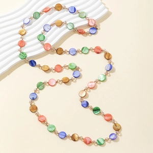 Detail of colorful shell disc necklace with natural luster and golden bead connectors