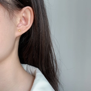 Delicate gold flower stud earrings for women featuring a minimalist floral design