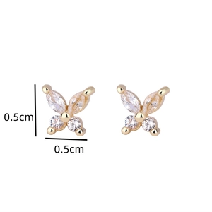 Detail shot of tiny gold butterfly studs with crystals, measuring 0.5cm by 0.5cm size