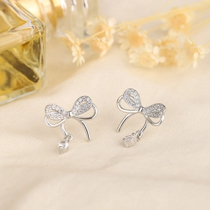 Silver S925 bowknot stud earrings with sparkling cubic zirconia in a lifestyle setting