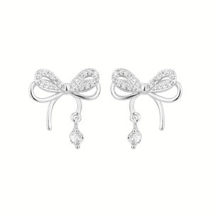 Macro detail of silver double bow earrings featuring sparkling pavé zircon stones