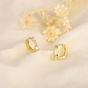 S925 sterling silver gold huggie earrings with small round zircon stones on beige fabric