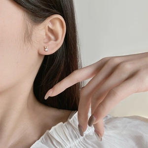 Elegant S925 silver rabbit stud earring with clear crystal on female model's ear
