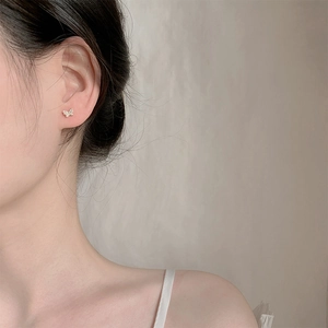 Elegant S925 silver butterfly stud earrings with sparkling crystals on model