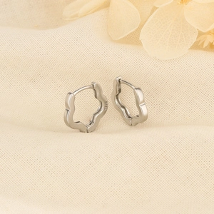 Elegant S925 sterling silver flower shaped hoop earrings on a soft linen background