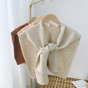 Detailed rib-knit texture and knot-style draping of versatile solid color shawls