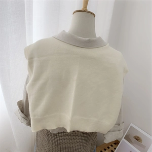 Solid knit scarf vest in cream white featuring ribbed hem over a grey shirt