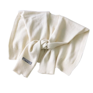 Knitted beige scarf wrap with elegant knot design and decorative label for women
