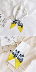 Detail of yellow and white skinny scarf with cartoon fox print on beige blazer