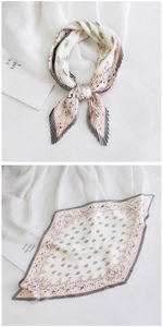 Detail of pleated silk scarf featuring grey pink gradient and floral paisley patterns