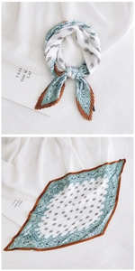 Detail of pleated silk scarf showing vintage floral print and decorative knot style