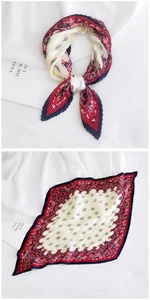 Close-up of pleated silk neck scarf featuring vintage paisley pattern and textured folds