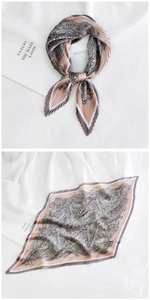 Macro detail of pleated paisley silk scarf in dusty rose and brown with elegant textures