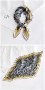 Detailed view of pleated square scarf with paisley pattern and ginger yellow borders