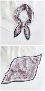 Close-up of pink and grey pleated scarf with paisley print tied in a delicate bow