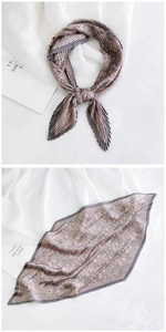 Detail of pleated paisley square scarf with earth tone vintage patterns and texture