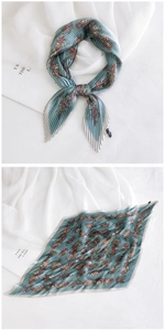 Macro detail of teal pleated silk scarf with colorful floral print and serrated edges