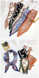 Close-up of elegant daisy print skinny silk scarves with satin finish and contrast borders